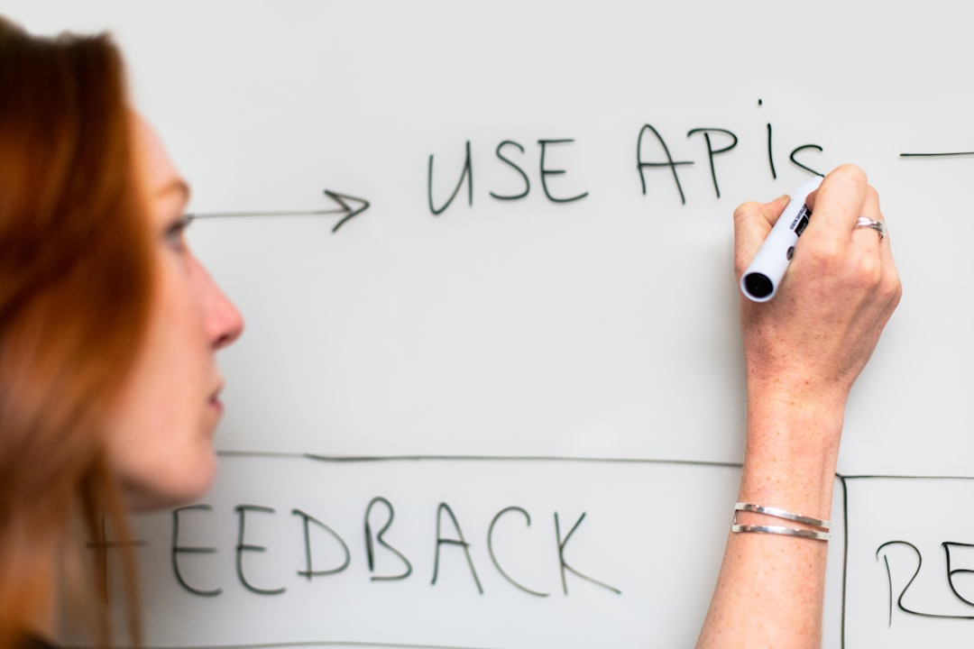 Person writing on a whiteboard — representing the traceability needed for continuous improvement evidence