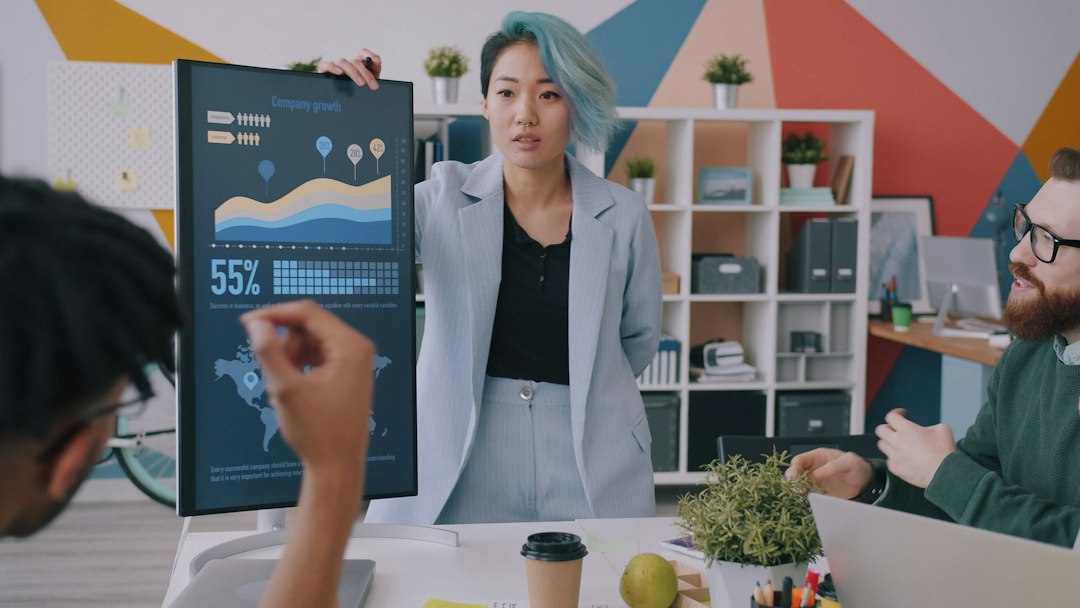 A professional presents a data dashboard to colleagues in a review meeting