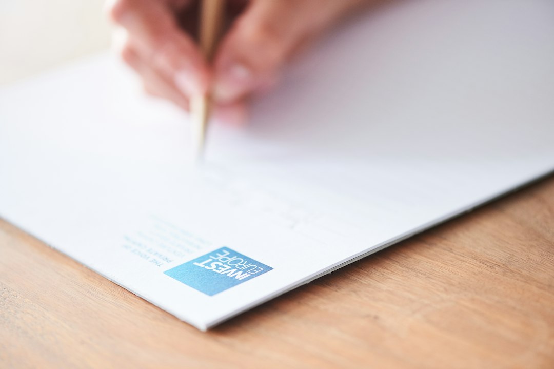 A hand writing an after-action note on paper, recording what happened and what changed