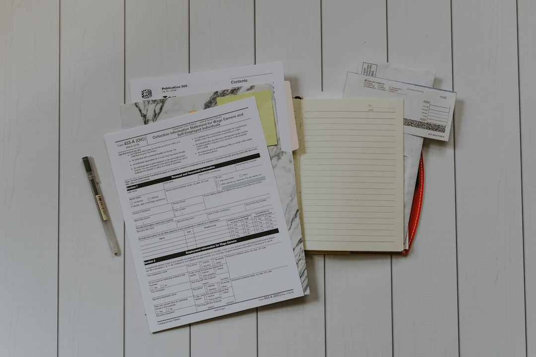A flat lay of printed paperwork and forms on a desk