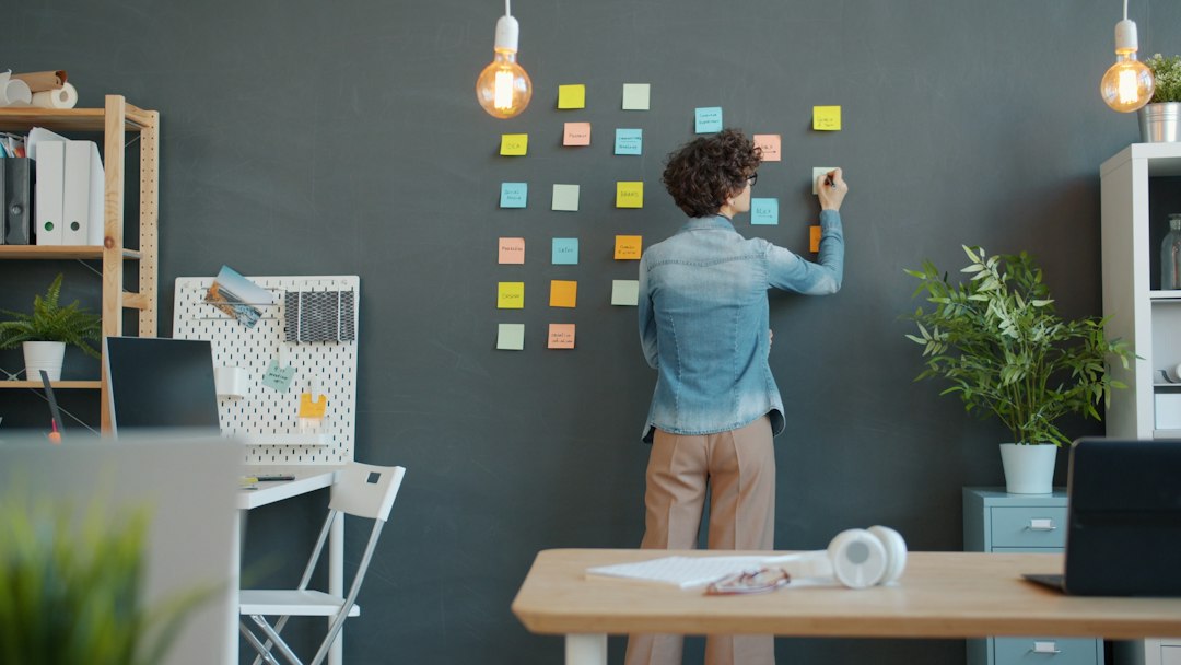 A coordinator assigning ownership with sticky notes