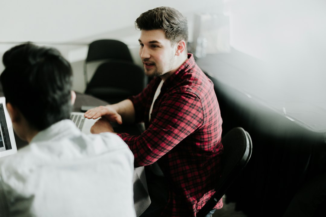 Coordinator and faculty member discussing evidence collection in a meeting