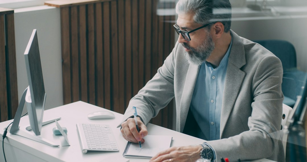 An experienced professional writing an incident note at his desk