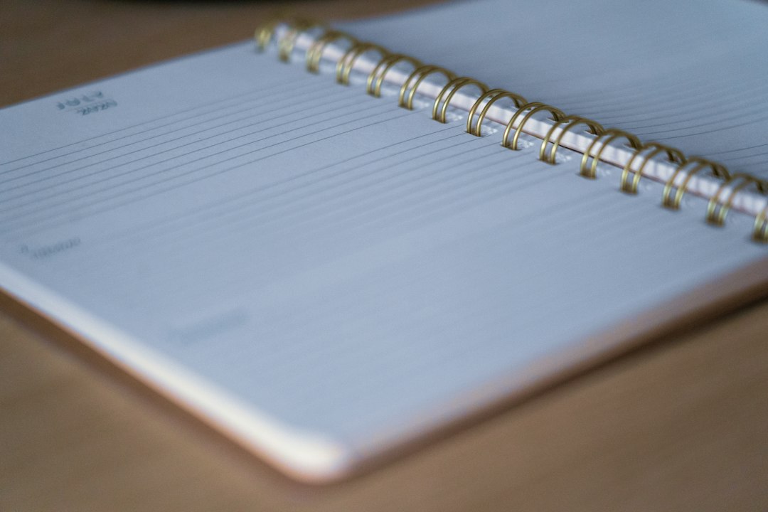 A blank spiral notebook open on a desk, the fresh start of an annual evidence review each year