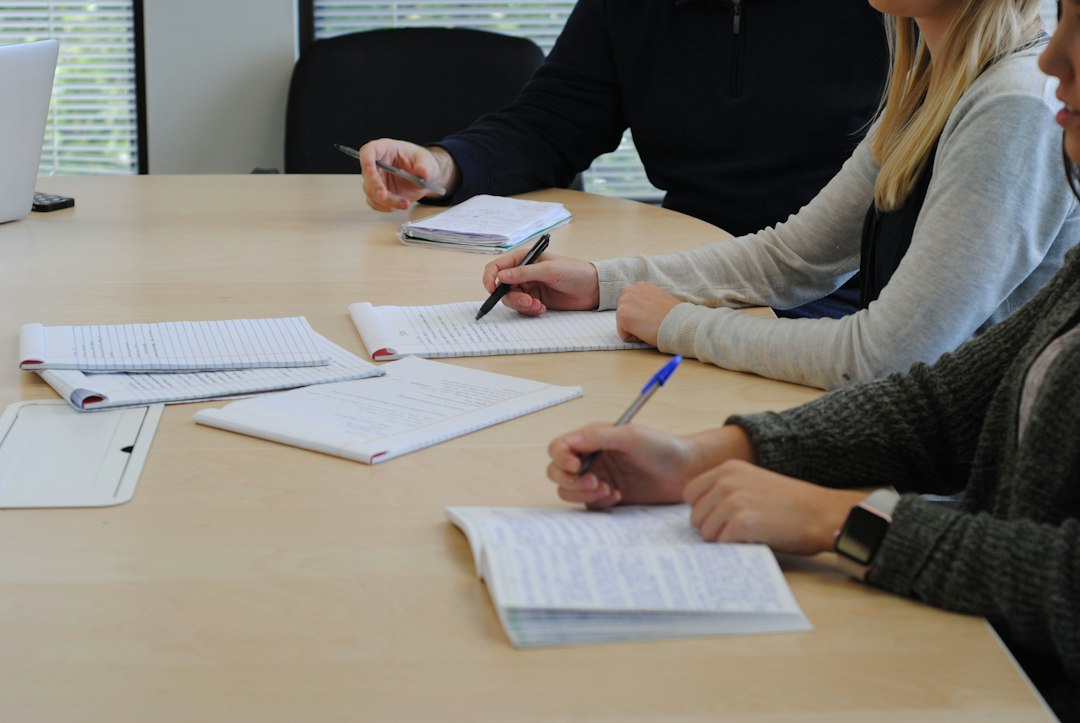 Several people reviewing and annotating documents at a table